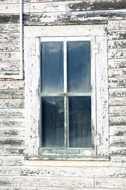 istock Abandoned building with stained window and worn siding 642650082