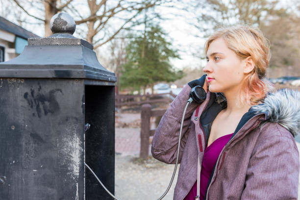 Young woman calling in phonebooth in winter