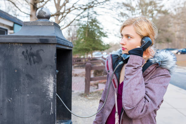 istock Young woman calling in phonebooth in winter 642655426