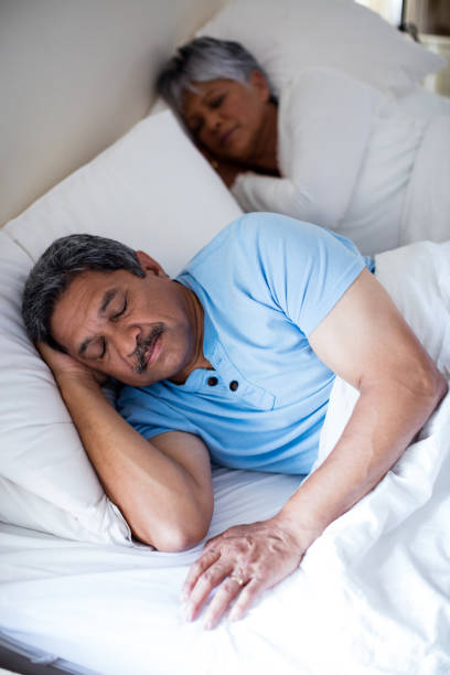 istock Senior couple sleeping together on bed in bedroom 642655444