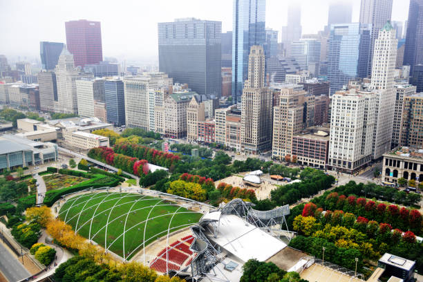Millennium Park and Michigan Avenue from above, Chicago Aerial view of South Michigan Avenue in The Loop, downtown Chicago. Cityscape with distant people  and  landmark  architecture.  Pritzker Pavillion and Millennium Park in the foreground. Misty autumn day. millennium park chicago stock pictures, royalty-free photos & images