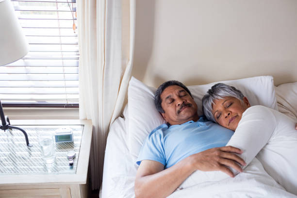 istock Senior couple sleeping together on bed in bedroom 642655972