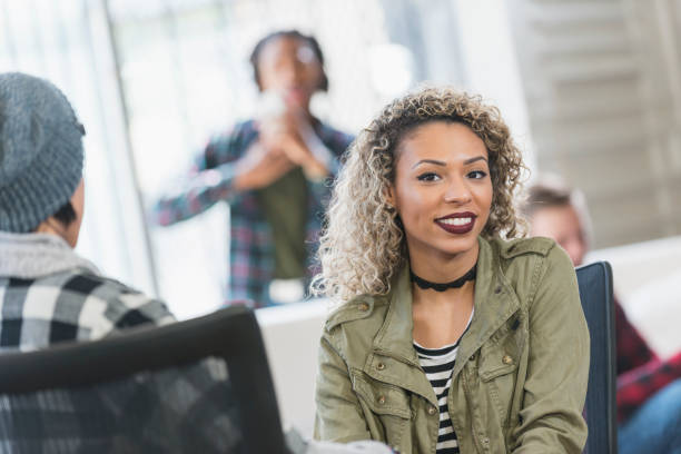 istock Young, trandy mixed race woman with group of creatives 642676480