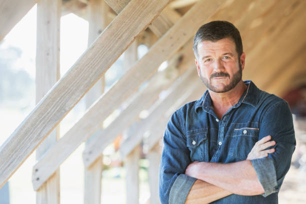 istock Mature man standing in barn 642677058