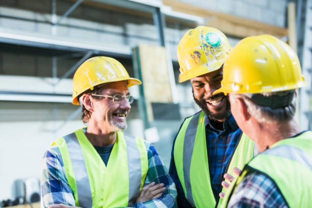 istock Three multi-ethnic workers with safety vests and hard hats 642677432