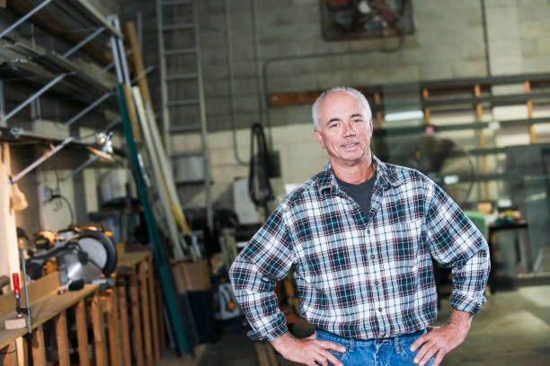 istock Mature man standing in factory workshop 642677530