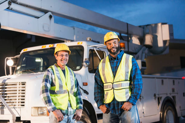 istock Two workmen in safety vests with truck 642677594