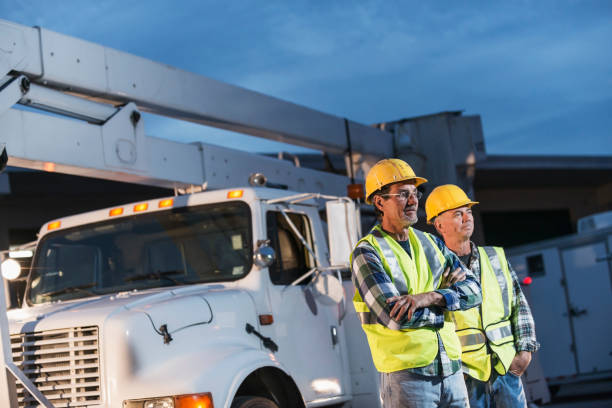 istock Two workmen in safety vests with truck 642677604