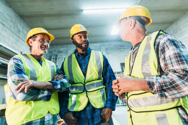 istock Three multi-ethnic workers with safety vests and hard hats 642677670