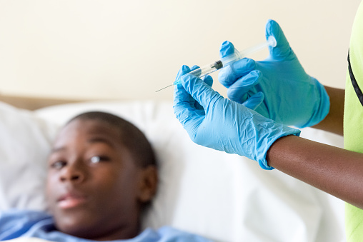 African american Teenage boy awaits shot from doctor