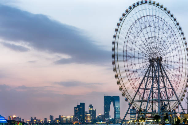 istock ferris wheel with cityscape in background 642686494