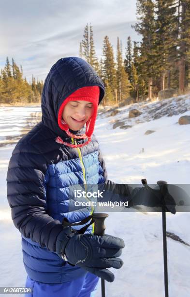 Happy Teenager With Downs Syndrome And Autism Snowshoeing Stock Photo - Download Image Now
