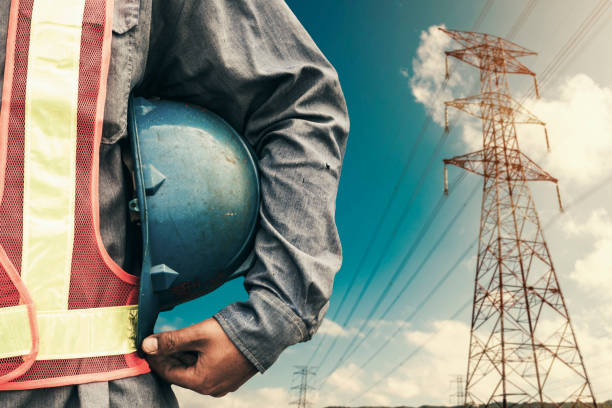 istock Engineer holding blue helmet standing on High-voltage tower 642687412