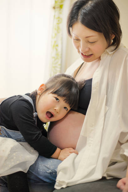 istock Pregnant mother and daughter having fun time at home 642704708