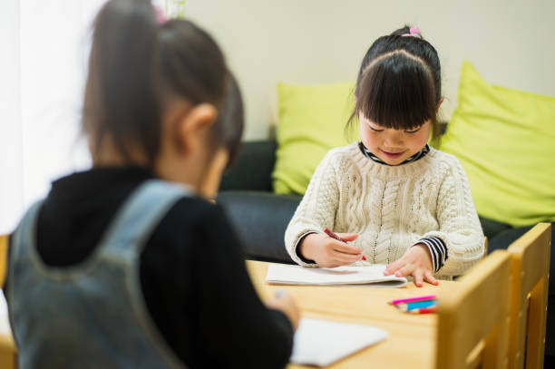 istock Japanese sisters drawing a picture together 642704798