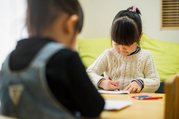 istock Japanese sisters drawing a picture together 642704824