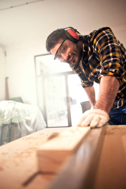 istock Carpenter cutting wooden plank 642715802