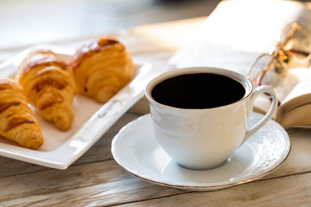 istock Croissants with coffee on the wooden table 642723980