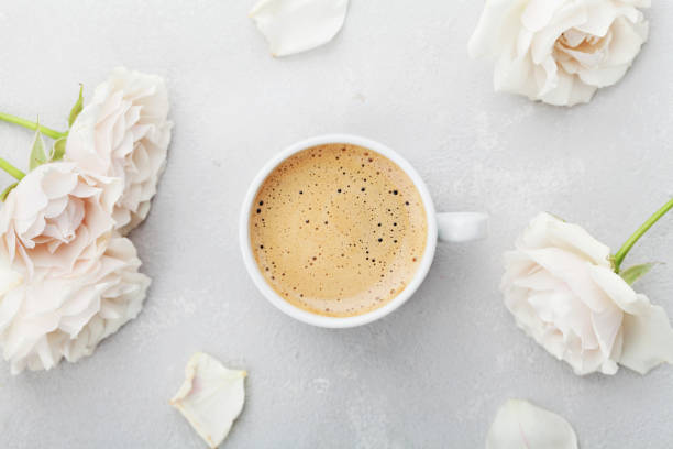 istock Coffee mug and vintage rose flowers. Flat lay style. 642727192