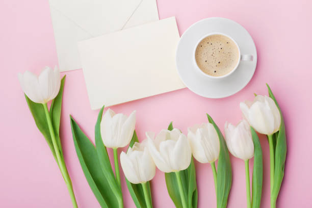 istock Coffee mug, paper card and spring tulip flowers. Flat lay. 642732080