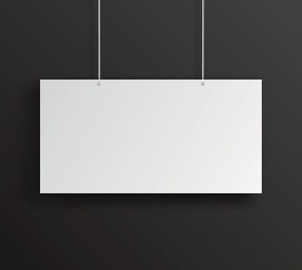 Blank white horizontal poster hanging on black wall