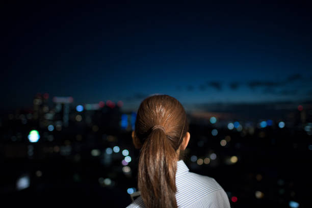 istock A beautiful woman looks at the night view. 642772150