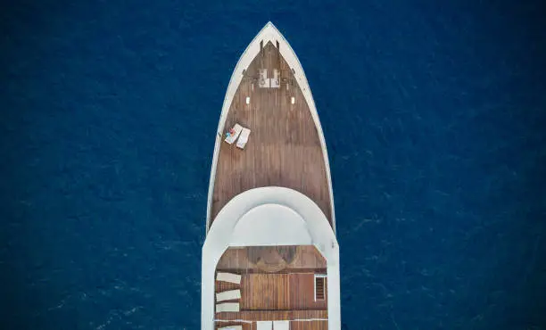 Aerial close-up view of big luxury yacht in sea, copyspace for text