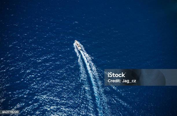 Aerial View Of Small Boat Flowing In Sea Stock Photo - Download Image Now - Speedboat, Maldives, Aerial View