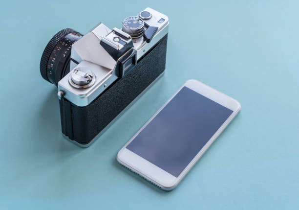 Vintage Camera And Modern Mobile Phone