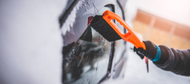 istock Woman cleaning a snow covered car 642812430