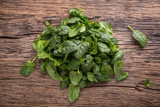 istock Spinach leaves.Fresh spinach leaves in retro bowl on oak wood board. Selective focus 642813508