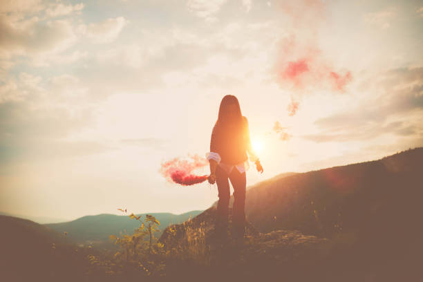 istock Woman with torch on mountain 642819362