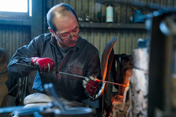 istock Glassblower heating his glass in a kiln 642828082