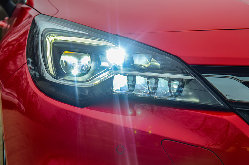 Budapest, Hungary - November 27, 2015: Close-up photo of matrix LED headlights of 2016 model year Opel Astra (generation K). Opel Astra is equipped with headlights that consist of 16 individual matrix LED units. Headlights provide adaptive and automatic management of illumination of nighttime roads.