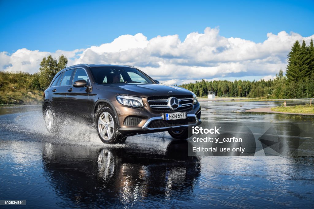 Mercedes-Benz GLC Hybrid Nokia, Finland - August 24, 2016: Summer tire test is held at the proving ground. Test-driver performs a wet handling test on Mercedes-Benz GLC to determine the tire which provides the best grip. Car Stock Photo