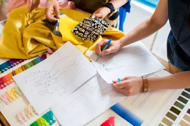 Photo of Overhead view of a team of fashion designers working