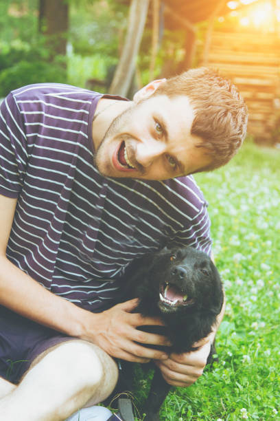 istock young man having a fun with dogs in the nature 642840896