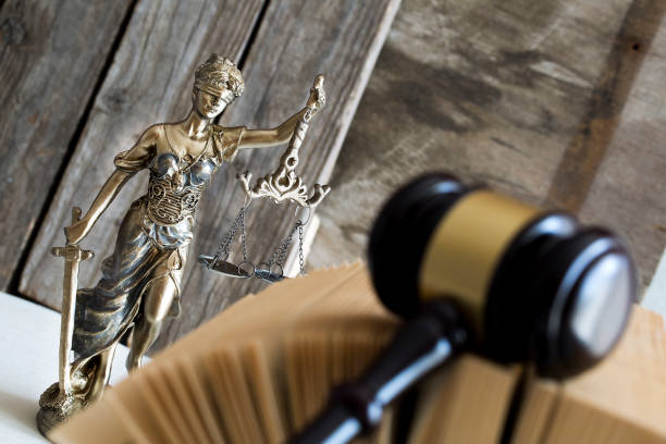 Law concept. Judge gavel, statue and book stock photo