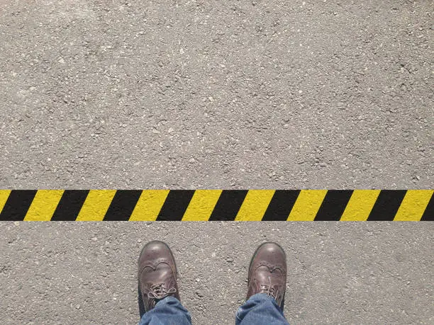 standing at the yellow-black line. Do not cross the line. It's prohibited and not allowed. It's limited. It's the end.