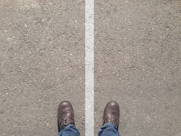 istock standing on the asphalt concrete floor and white line between his legs 642841746