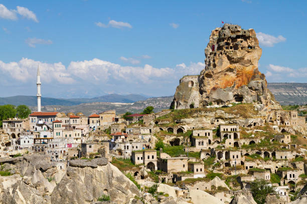 View over the town of Ortahisar with its cave dwellings and old houses in Cappadocia. Ortahisar, Cappadocian town. phallus shaped stock pictures, royalty-free photos & images