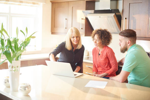 istock couple with estate agent looking at deals 642872806