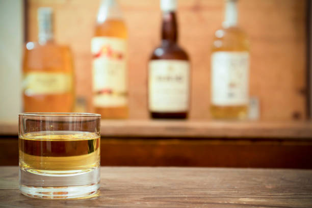 istock glass with whisky on wooden table 642873206
