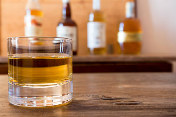 istock glass with whisky on wooden table 642873212