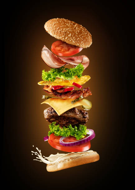istock Maxi hamburger with flying ingredients on dark background 642882230