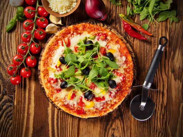 istock Pizza with ingredients served on wood 642884630