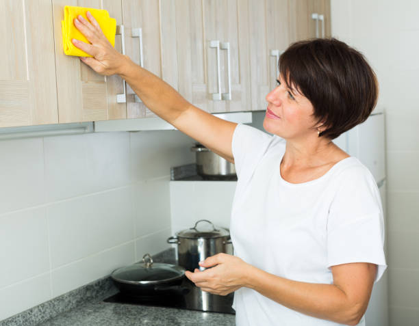 istock retiree woman cleaning home 642885252
