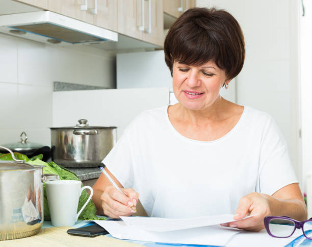 istock happy woman paying bills 642885304