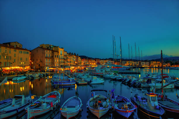 St.Tropez. France - September 27, 2013: St. Tropez  port by night where stay many yachts, boats.  Here are walking a lot of people among shops and restaurants.