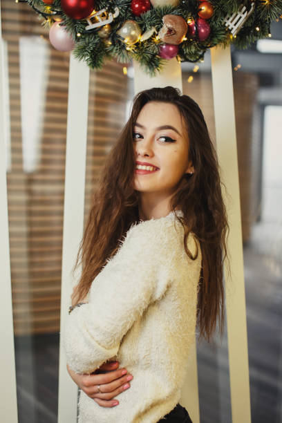 istock Girl standing in holiday background and looking at camera 642902386